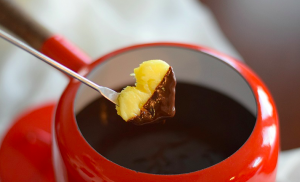 pineapple heart dipped into chocolate fondue for Valentine's Day