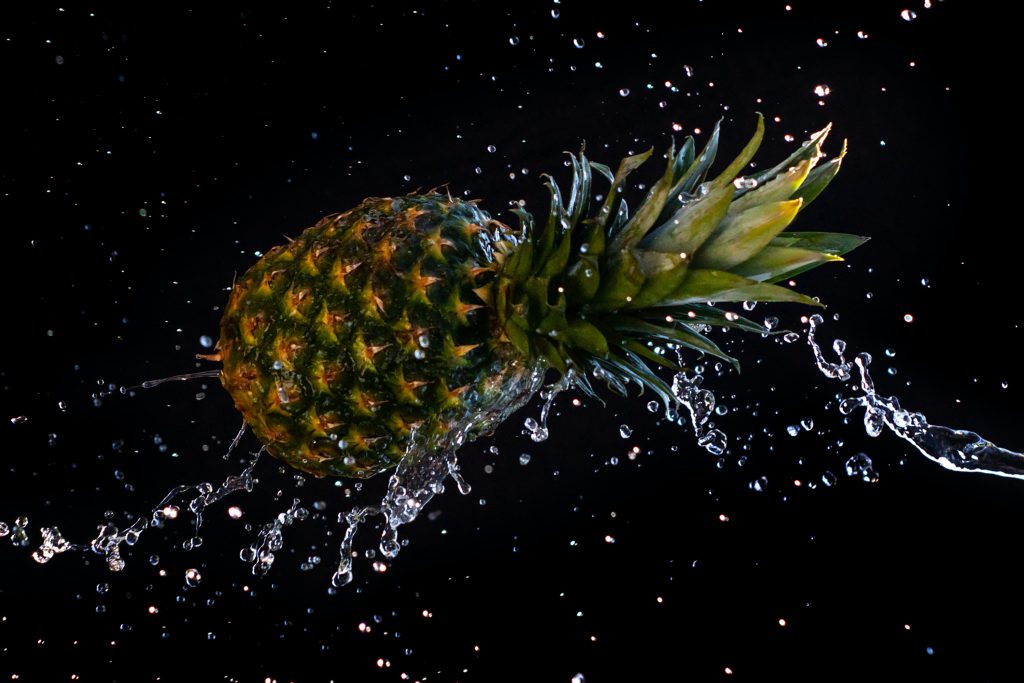 Pineapple splashing with water