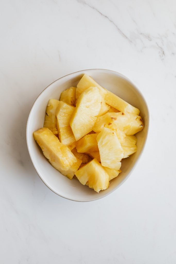 a bowl of pineapples for Pineapple Romanoff