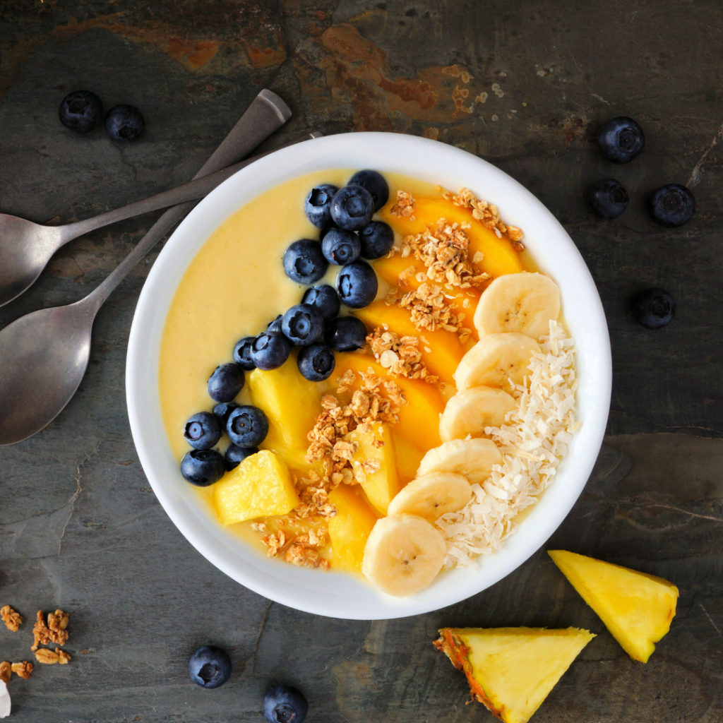 Chestnut Hill Farms pineapple mango smoothie bowl with yoghurt, blueberries, banana and granola.