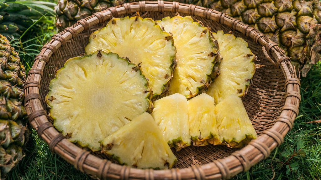 a basket of chopped pineapple slices
