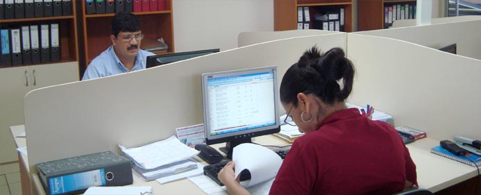 Carlos Esquivel and Edith Valladares jump though the many hoops of importing & exporting.