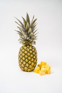 Pineapple with pineapple chunks to the right