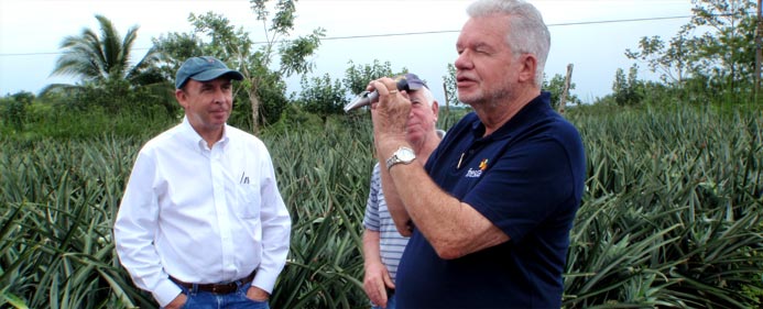 Checking Brix. From left: Trond Jensen, John Ordman, Dr. Lloyd Berg.